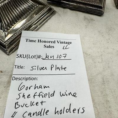 Sale Photo Thumbnail #180: 4 heavy candle sticks ( no markings) Gorham clam shell, Ice bucket, Shelffield England Pitcher and aluminim hammered plate Japan.