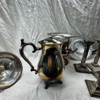 Sale Photo Thumbnail #178: 4 heavy candle sticks ( no markings) Gorham clam shell, Ice bucket, Shelffield England Pitcher and aluminim hammered plate Japan.