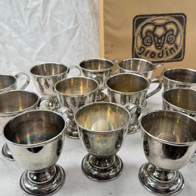 Sale Photo Thumbnail #200: These are vintage silver-plated punch cups, likely part of a larger punch bowl service. 

They are typically made of electro-plated nickel silver (EPNS). 
The cups feature a footed base and a single handle.
They are often part of a set including a punch b