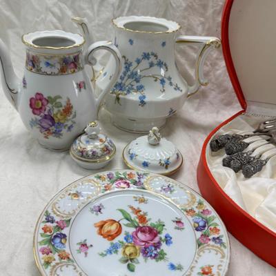 Sale Photo Thumbnail #214: Set of floral Hors d'oeuvre spoons, forks in original red case. Divided olive glass bowl with silver foot ( unmarked) 2 fine bone china tea pots one with matching plate.
