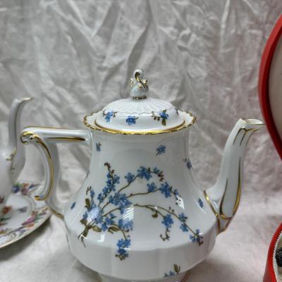 Sale Photo Thumbnail #207: Set of floral Hors d'oeuvre spoons, forks in original red case. Divided olive glass bowl with silver foot ( unmarked) 2 fine bone china tea pots one with matching plate.