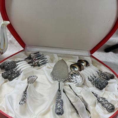 Sale Photo Thumbnail #204: Set of floral Hors d'oeuvre spoons, forks in original red case. Divided olive glass bowl with silver foot ( unmarked) 2 fine bone china tea pots one with matching plate.