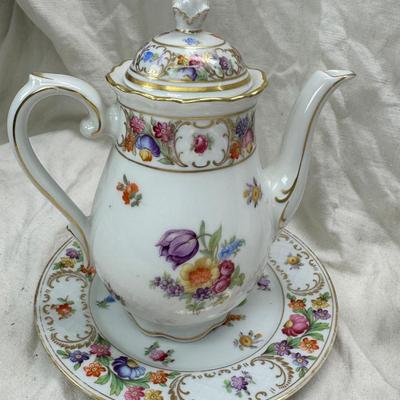 Sale Photo Thumbnail #210: Set of floral Hors d'oeuvre spoons, forks in original red case. Divided olive glass bowl with silver foot ( unmarked) 2 fine bone china tea pots one with matching plate.
