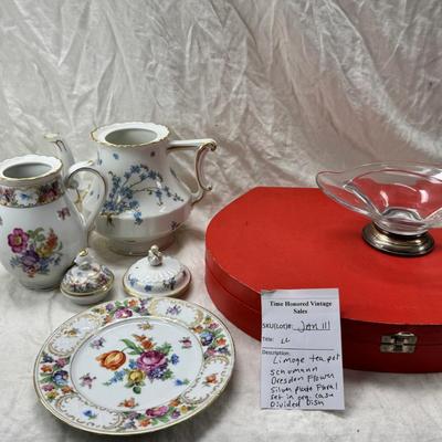 Sale Photo Thumbnail #218: Set of floral Hors d'oeuvre spoons, forks in original red case. Divided olive glass bowl with silver foot ( unmarked) 2 fine bone china tea pots one with matching plate.