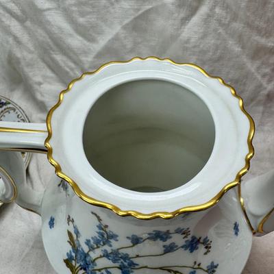Sale Photo Thumbnail #208: Set of floral Hors d'oeuvre spoons, forks in original red case. Divided olive glass bowl with silver foot ( unmarked) 2 fine bone china tea pots one with matching plate.