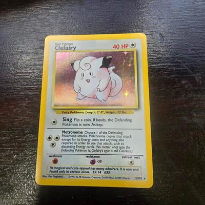 Sale Photo Thumbnail #27: Pokemon TCG Clefairy card from the 1999 Base Set, numbered 5/102. Holographic finish with 40 HP. Displays light play with minor signs of wear visible on edges and surface. Includes descriptions of attacks: Sing and Metronome. Dimensions are standard for t