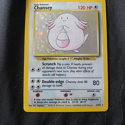 Sale Photo Thumbnail #31: 1999 Pokemon Base Set Holo Chansey card #3/102. Features holographic art of Chansey with 120 HP. Card text includes the moves Scrunch and Double-edge. Condition is light play, with visible signs of handling and minor surface wear. Refer to images for deta