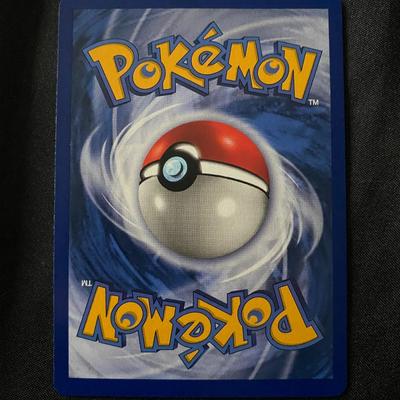 Sale Photo Thumbnail #40: Pokemon Clefairy holographic trading card, number 5/102 from the Base Set. Printed in French. Features a light play condition reflected in minor surface and edge wear visible under close inspection. Displays traditional artwork with holofoil background. A