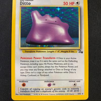 Sale Photo Thumbnail #47: Pokemon Fossil Ditto card with 50 HP, marked as card 18/62 from the Fossil series. The card has a yellow-bordered design and showcases the Transform ability. Condition noted as light play, with minor wear visible on both the front and back surfaces. No ma