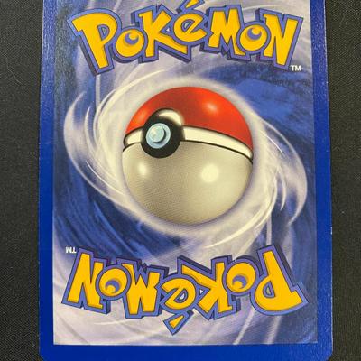 Sale Photo Thumbnail #54: Electrode holographic card from the 1999 Wizards of the Coast Base Set (144/144). Features 90 HP and Chain Lightning attack. Condition is light play with minor wear visible on the edges and surface. A highly sought-after piece for collectors. Back of the 