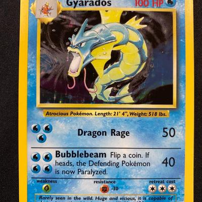 Sale Photo Thumbnail #59: Pokemon TCG Gyarados card from the Base Set, numbered 41/102. Features 100 HP and attacks Dragon Rage and Bubblebeam. The card shows condition of light play, with visible wear consistent with slight usage. Illustrator is Mitsuhiro Arita. Card is in Englis