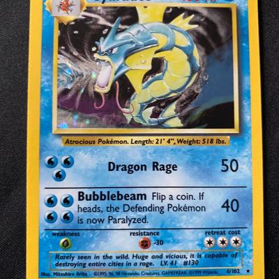 Sale Photo Thumbnail #65: This listing is for a Pokemon Gyarados 6/102 holofoil card from the original Base Set. The card features a holographic image with a light play condition. It has 100 HP and includes the Dragon Rage and Bubblebeam attacks. This card displays the trademark W