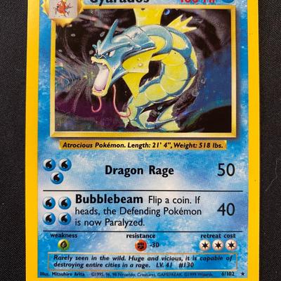 Sale Photo Thumbnail #73: Original Pokemon Base Set 2 Gyarados holographic card, 1st edition. Card number 6/130 with light play condition. Features Dragon Rage (50 damage) and Bubblebeam (40 damage). Printed in 1999 by Wizards of the Coast. Displays minor wear consistent with ligh