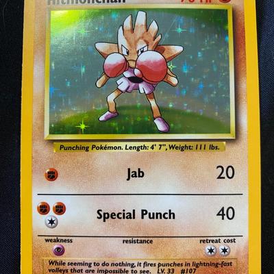 Sale Photo Thumbnail #89: Pokemon Hitmonchan holographic card from the Base Set. Numbered 7/102. Features 70 HP and attacks Jab (20) and Special Punch (40). The card is in light play condition with visible holographic foil on the illustration background. Manufactured by Wizards of