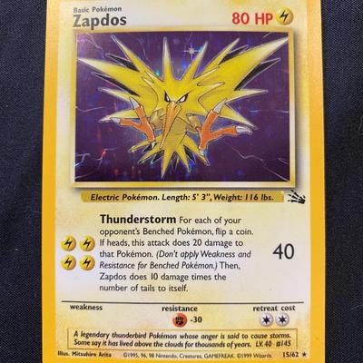 Sale Photo Thumbnail #101: 1999 Pokemon card featuring Zapdos from the base expansion set. Card number 16/102. Not first edition. Condition: light play with minor surface wear, no major creases. Original backing intact and overall light to moderate handling evident.