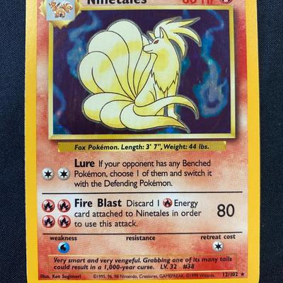 Sale Photo Thumbnail #117: Pokemon trading card featuring Ninetales from the Base Set, originally released in 1999. Card number 12/102. The card is holographic with light play condition. Displays minor signs of handling but no major damage.