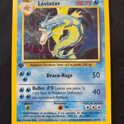 Sale Photo Thumbnail #137: First Edition holographic Pokemon card featuring LÃ©vizator from the French print of the Base Set. Card number 6/102. Displays light play condition. Attributes include 100 HP; moves: Draco-Rage and Bulles d'O. Language: French. A collector's item from t
