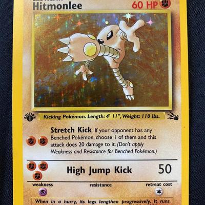 Sale Photo Thumbnail #143: This is a first edition holographic Hitmonlee card from the PokÃ©mon Trading Card Game. The card originates from the Fossil set and is numbered 7/62. It is in light play condition, showing some signs of prior use but remains intact and collectible. The 