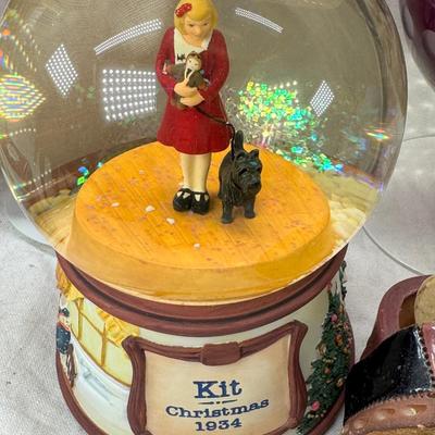 Sale Photo Thumbnail #230: Purple bohemian glass vase with small chip in rim, Resin camel 4 working music boxes, 1 Christmas snow globe.