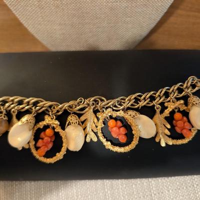 Chunky gold tone fall charm bracelet.