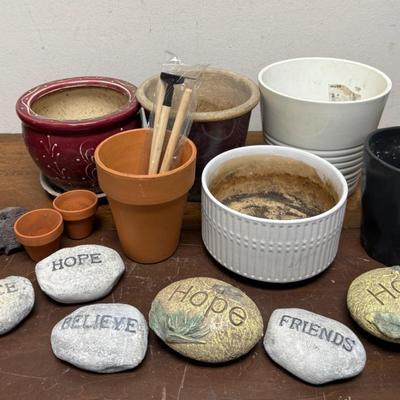 Sale Photo Thumbnail #533: Assorted ceramic and clay pots, river rocks with words like "friends", "hope", and "believe", and some small gardening tools. Good used condition.