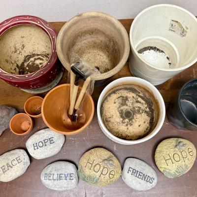 Sale Photo Thumbnail #531: Assorted ceramic and clay pots, river rocks with words like "friends", "hope", and "believe", and some small gardening tools. Good used condition.