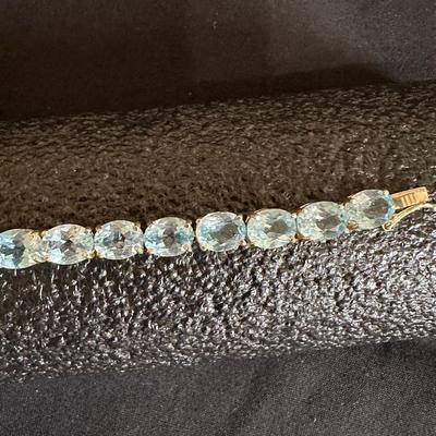 .925 STERLING SILVER TENNIS BRACELET WITH LIGHT BLUE STONES
