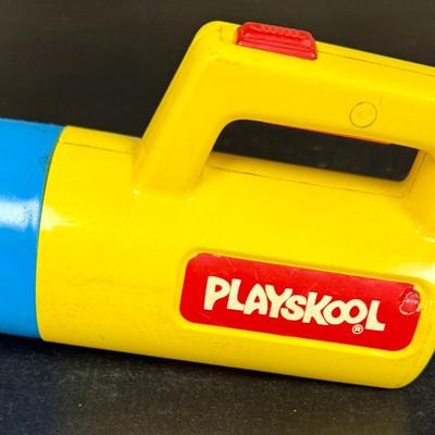 Sale Photo Thumbnail #556: Vintage Playskool color-changing toy flashlight, originally released around 1986. Has a knob to change the lens from red to clear to green. Untested, but appears to be in good working condition.