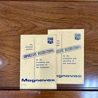 Sale Photo Thumbnail #574: From the early 1970's, pecan finish. Untested. Contains a record player and AM/FM Stereo Receiver Caster wheels underneath to make repositioning easy. Measures approx. 54" x 20" x 27" high. Speakers measure 16" x 11" x 23" high. Includes original paperwor