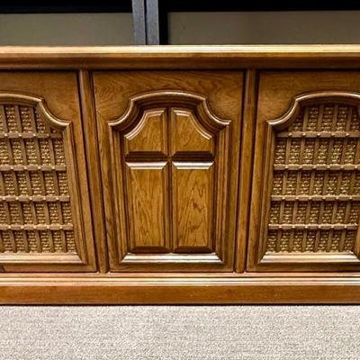Sale Photo Thumbnail #568: From the early 1970's, pecan finish. Untested. Contains a record player and AM/FM Stereo Receiver Caster wheels underneath to make repositioning easy. Measures approx. 54" x 20" x 27" high. Speakers measure 16" x 11" x 23" high. Includes original paperwor