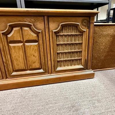 Sale Photo Thumbnail #570: From the early 1970's, pecan finish. Untested. Contains a record player and AM/FM Stereo Receiver Caster wheels underneath to make repositioning easy. Measures approx. 54" x 20" x 27" high. Speakers measure 16" x 11" x 23" high. Includes original paperwor