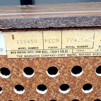 Sale Photo Thumbnail #589: From the early 1970's, pecan finish. Untested. Contains a record player and AM/FM Stereo Receiver Caster wheels underneath to make repositioning easy. Measures approx. 54" x 20" x 27" high. Speakers measure 16" x 11" x 23" high. Includes original paperwor