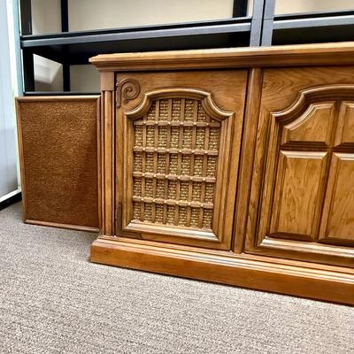 Sale Photo Thumbnail #569: From the early 1970's, pecan finish. Untested. Contains a record player and AM/FM Stereo Receiver Caster wheels underneath to make repositioning easy. Measures approx. 54" x 20" x 27" high. Speakers measure 16" x 11" x 23" high. Includes original paperwor