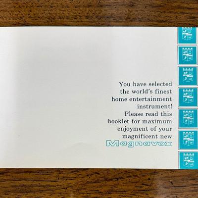 Sale Photo Thumbnail #578: From the early 1970's, pecan finish. Untested. Contains a record player and AM/FM Stereo Receiver Caster wheels underneath to make repositioning easy. Measures approx. 54" x 20" x 27" high. Speakers measure 16" x 11" x 23" high. Includes original paperwor