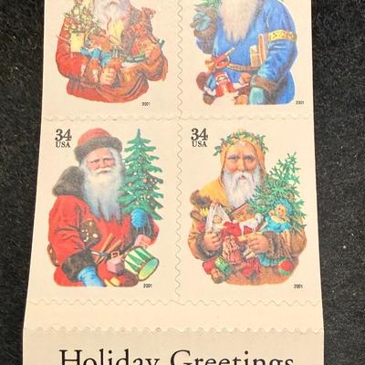 Sale Photo Thumbnail #590: This is a block of four 2001 34c Holiday Santas stamps, Scott #3537a-3540a. New condition.