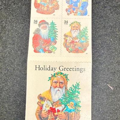 Sale Photo Thumbnail #591: This is a block of four 2001 34c Holiday Santas stamps, Scott #3537a-3540a. New condition.