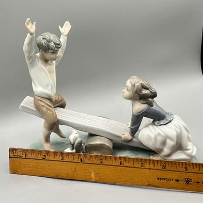 LOT 47: Lladro Children Playing SeeSaw Figurine