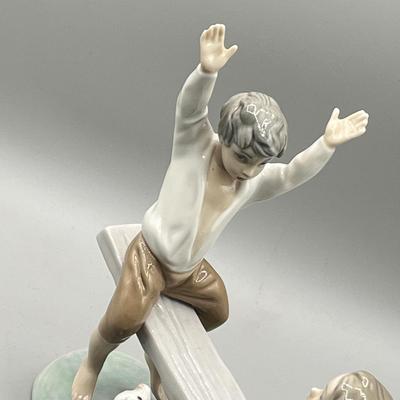 LOT 47: Lladro Children Playing SeeSaw Figurine