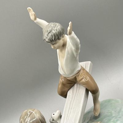 LOT 47: Lladro Children Playing SeeSaw Figurine