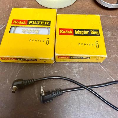 Sale Photo Thumbnail #608: From the late 70’s, includes custom fabric nick strap, matched Konica Autowinder, Konica 50mm lens with Asanuma 55mm Skylight 1A filter, Soligor 35-105mm zoom lens with Macro, Hoya 72mm Skylight 1B filter and case, extra filter and adapter ring, auto re