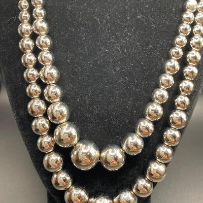 Silver tone graduated ball necklaces