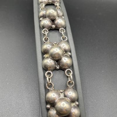 Silver tone bracelets and Mexican screwback earrings