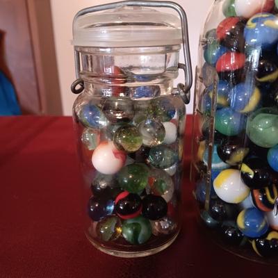 1 QUART JAR AND A SMALLER JAR OF MARBLES