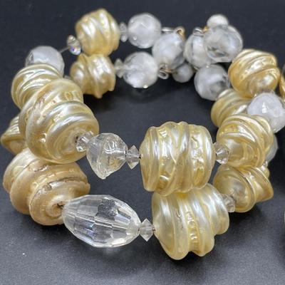 Cream and gold tone bracelets