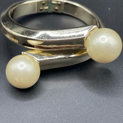 Cream and gold tone bracelets