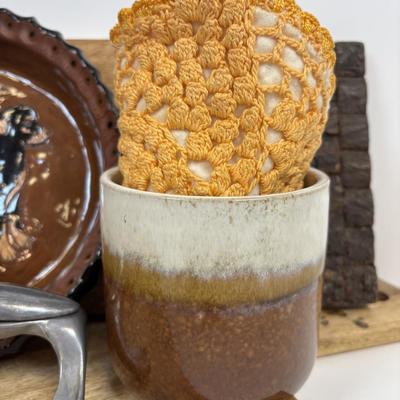 LOT 28: Wooden Charcuterie Boards, Vintage Wear-Ever Citrus Juicer, Crocheted Potholders, A. Loercher Earthenware/ Pottery Pie Plate...