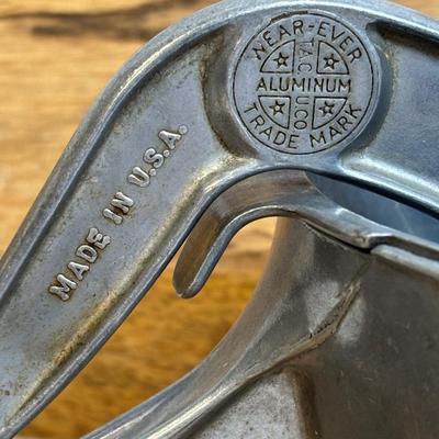 LOT 28: Wooden Charcuterie Boards, Vintage Wear-Ever Citrus Juicer, Crocheted Potholders, A. Loercher Earthenware/ Pottery Pie Plate...