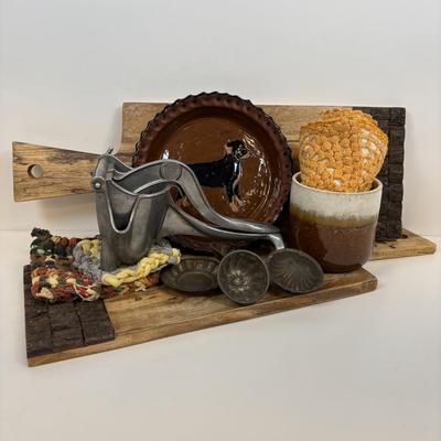 LOT 28: Wooden Charcuterie Boards, Vintage Wear-Ever Citrus Juicer, Crocheted Potholders, A. Loercher Earthenware/ Pottery Pie Plate...