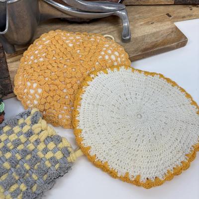 LOT 28: Wooden Charcuterie Boards, Vintage Wear-Ever Citrus Juicer, Crocheted Potholders, A. Loercher Earthenware/ Pottery Pie Plate...