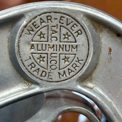 LOT 28: Wooden Charcuterie Boards, Vintage Wear-Ever Citrus Juicer, Crocheted Potholders, A. Loercher Earthenware/ Pottery Pie Plate...